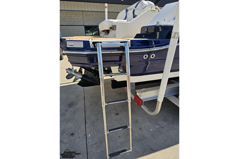 Slide: The Image of 2013 Monterey M3 Sport Boat with ladder and propeller, parked on concrete surface. - 32