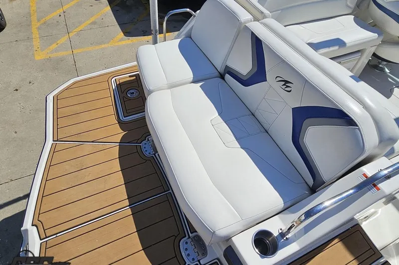 Slide: The Image of 2013 Monterey M3 Sport Boat with white and blue seating on a wooden deck. - 33