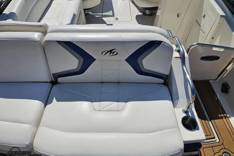 Slide: The Image of 2013 Monterey M3 Sport Boat interior with white and blue seating. - 38