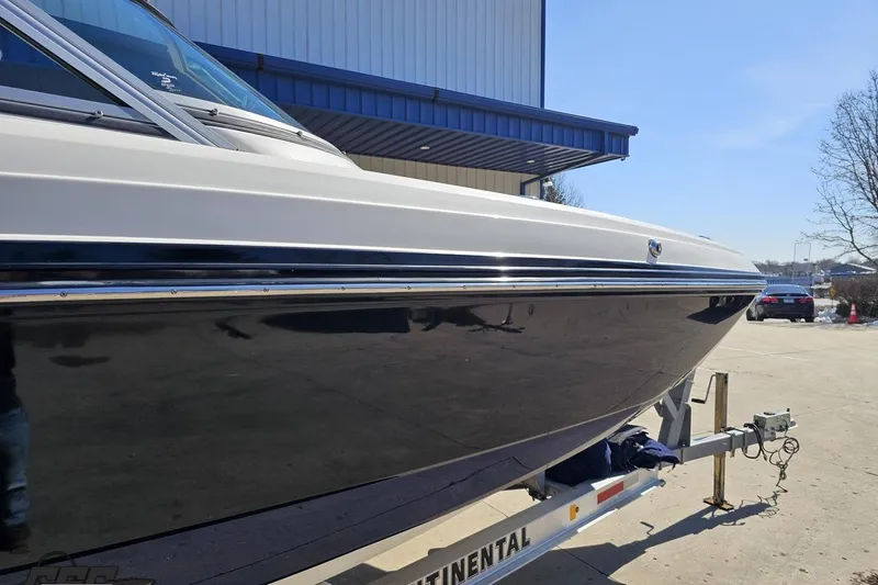 Slide: The Image of 2013 Monterey M3 Sport Boat on trailer, parked outdoors near a building. - 4