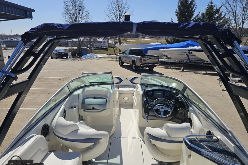 Slide: The Image of 2013 Monterey M3 Sport Boat interior with steering wheel and seating, parked outdoors. - 46