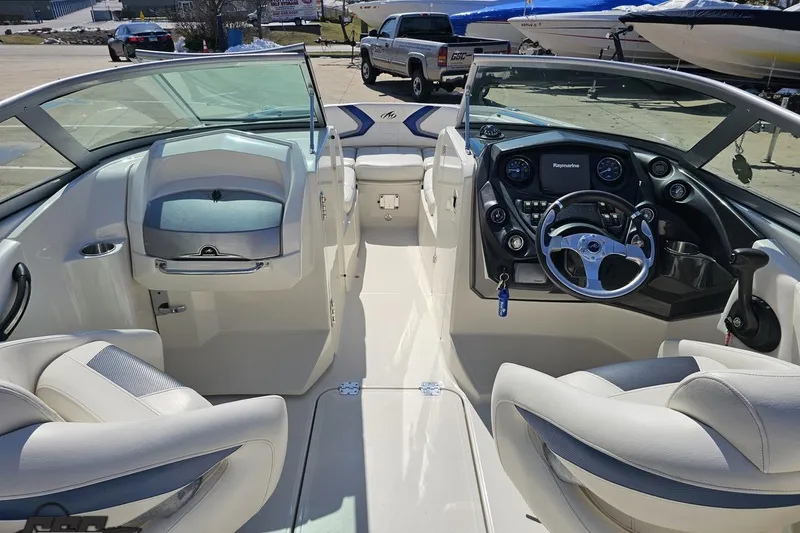 Slide: The Image of 2013 Monterey M3 Sport Boat interior with steering wheel and seating, parked outdoors. - 51
