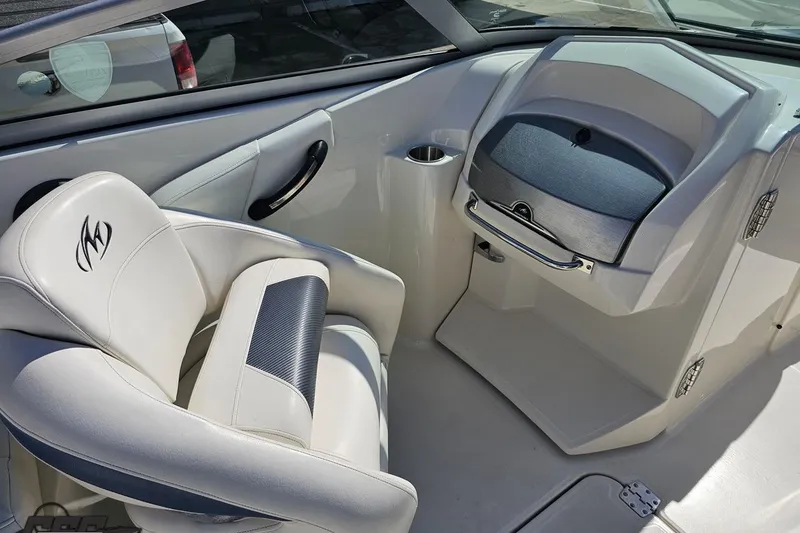 Slide: The Image of Interior of a 2013 Monterey M3 Sport Boat featuring a sleek white seat and dashboard. - 54