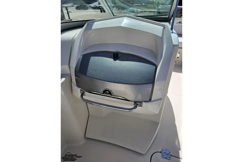 Slide: The Image of Dashboard of a 2013 Monterey M3 Sport Boat with storage compartment. - 57