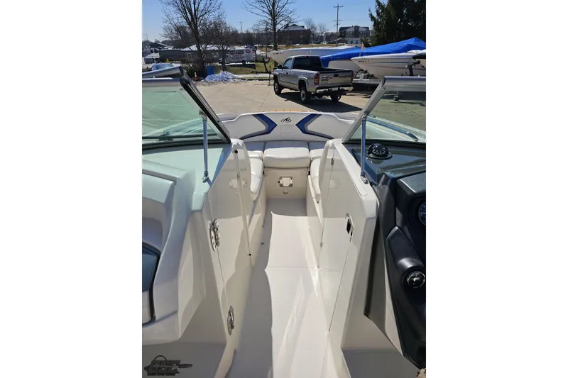Slide: The Image of 2013 Monterey M3 Sport Boat interior with open cockpit and seating, parked outdoors. - 65