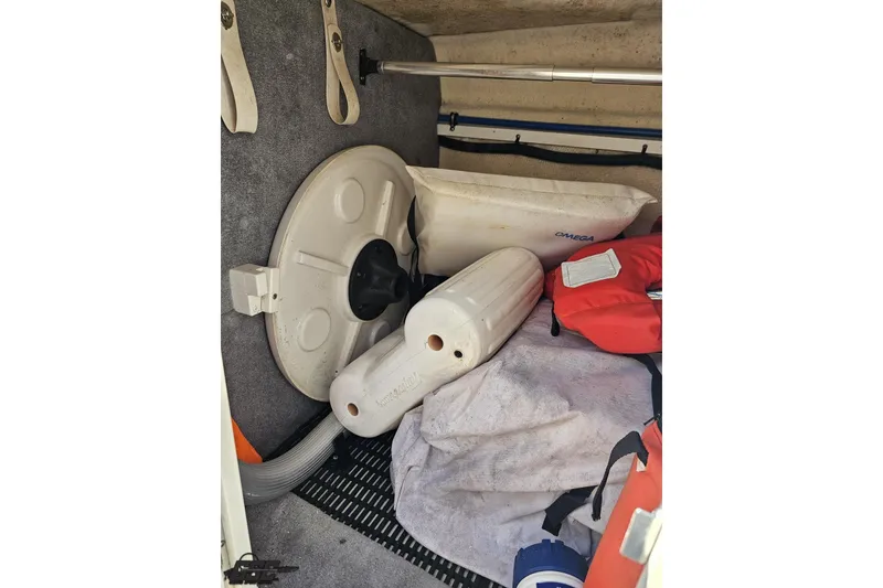Slide: The Image of Storage compartment of 2013 Monterey M3 Sport Boat with life jackets and fenders. - 68