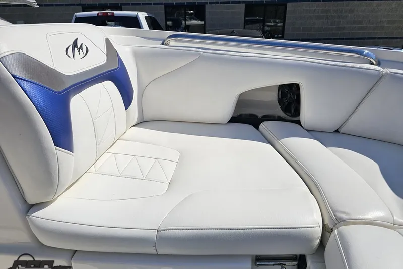Slide: The Image of 2013 Monterey M3 Sport Boat interior with white and blue cushioned seating. - 73