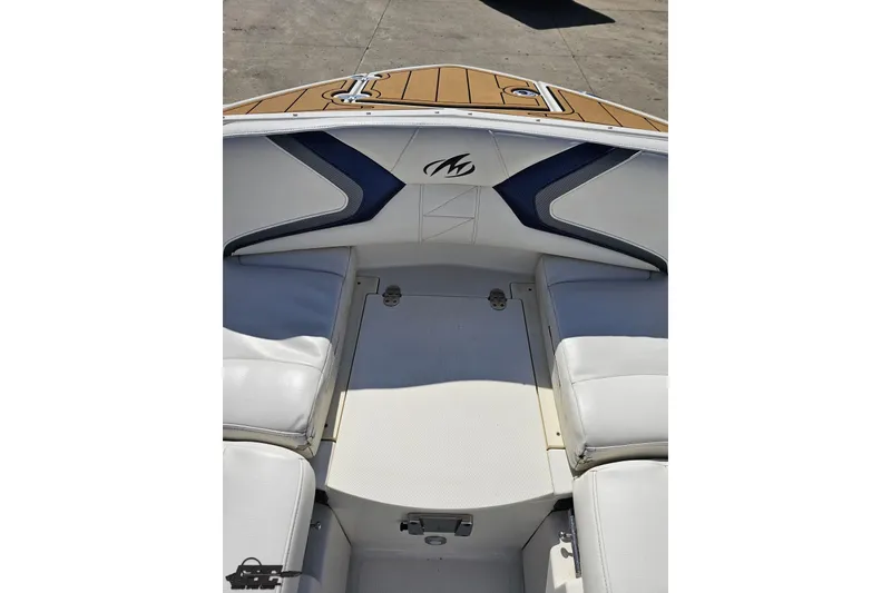 Slide: The Image of 2013 Monterey M3 Sport Boat interior with white seating and teak flooring. - 75