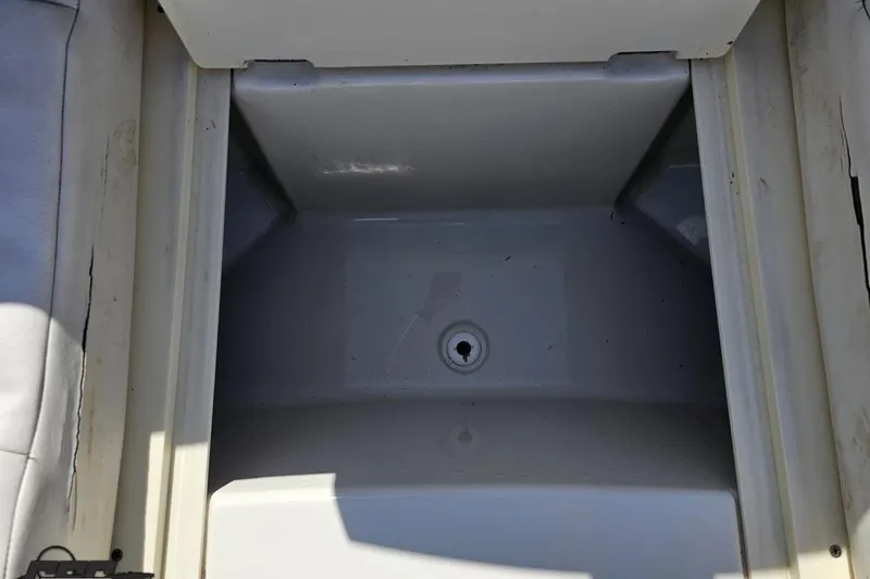 Slide: The Image of Storage compartment of a 2013 Monterey M3 Sport Boat, featuring a drain plug. - 76
