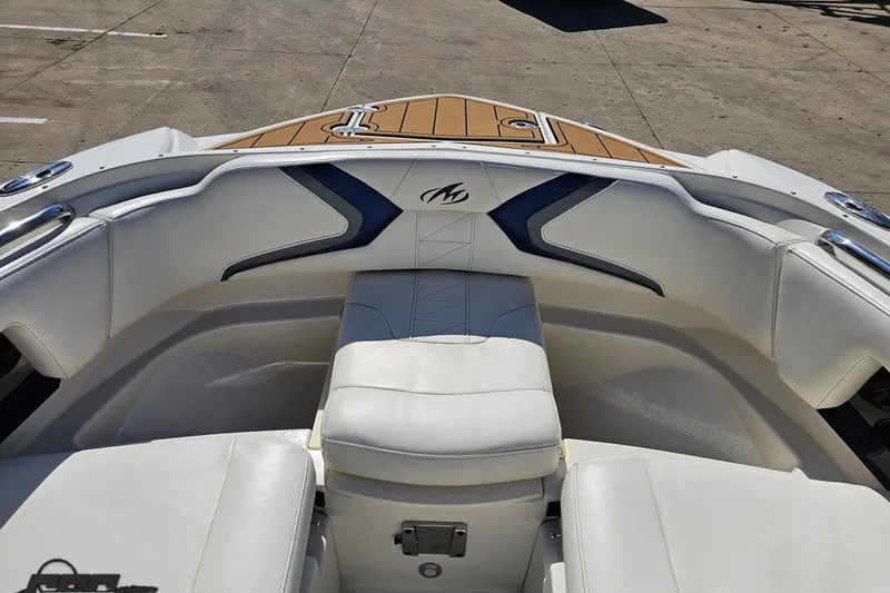 Slide: The Image of Interior view of a 2013 Monterey M3 Sport Boat with white seating and wood accents. - 77