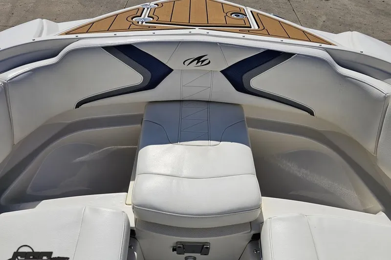Slide: The Image of Interior of a 2013 Monterey M3 Sport Boat with white seating and wood accents. - 78