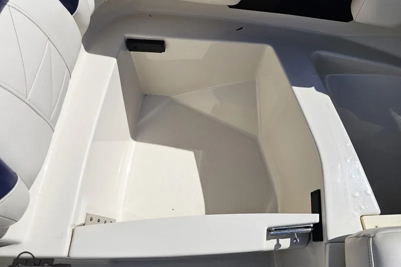 Slide: The Image of Storage compartment in a 2013 Monterey M3 Sport Boat, featuring white and blue seating. - 81