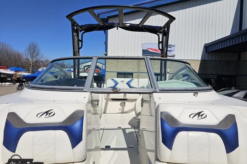 Slide: The Image of 2013 Monterey M3 Sport Boat with blue and white interior, parked outdoors. - 87