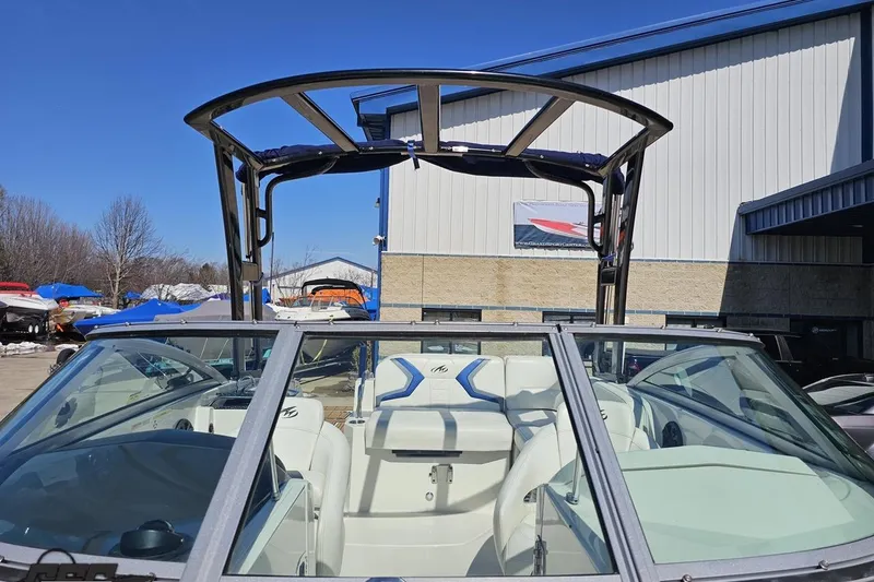 Slide: The Image of 2013 Monterey M3 Sport Boat with sleek design, parked outdoors under clear blue sky. - 88