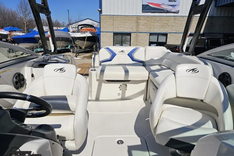 Slide: The Image of 2013 Monterey M3 Sport Boat interior with white seating and steering wheel. - 89