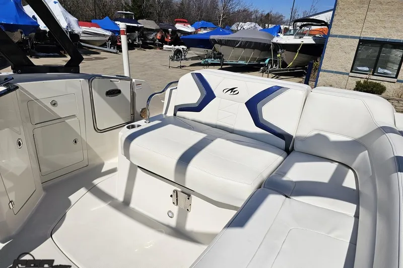 Slide: The Image of 2013 Monterey M3 Sport Boat interior with white seating and blue accents. - 92