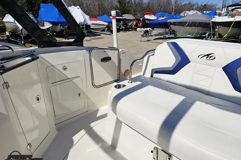 Slide: The Image of 2013 Monterey M3 Sport Boat interior with white seating and storage compartments. - 93