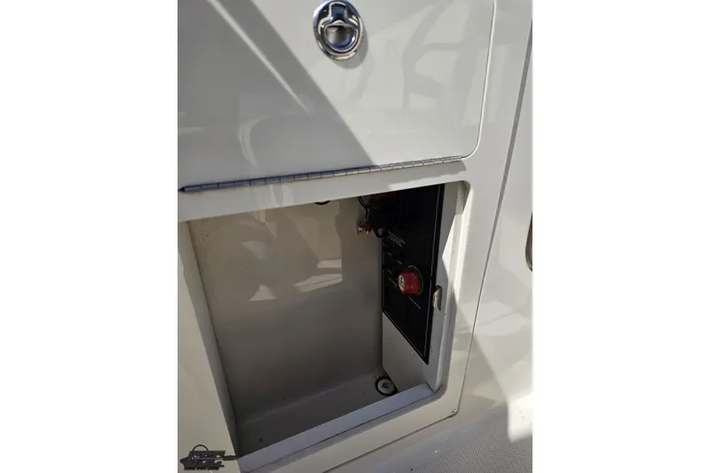 Slide: The Image of 2013 Monterey M3 Sport Boat storage compartment with control panel and latch. - 96