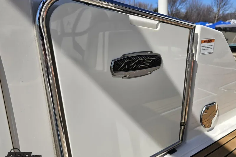 Slide: The Image of 2013 Monterey M3 Sport Boat emblem on sleek white exterior with chrome accents. - 97