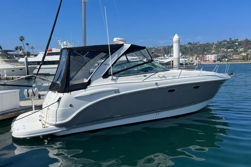 Slide: The Image of 2007 Chaparral Signature 330 boat docked in a marina under clear blue skies. - 0
