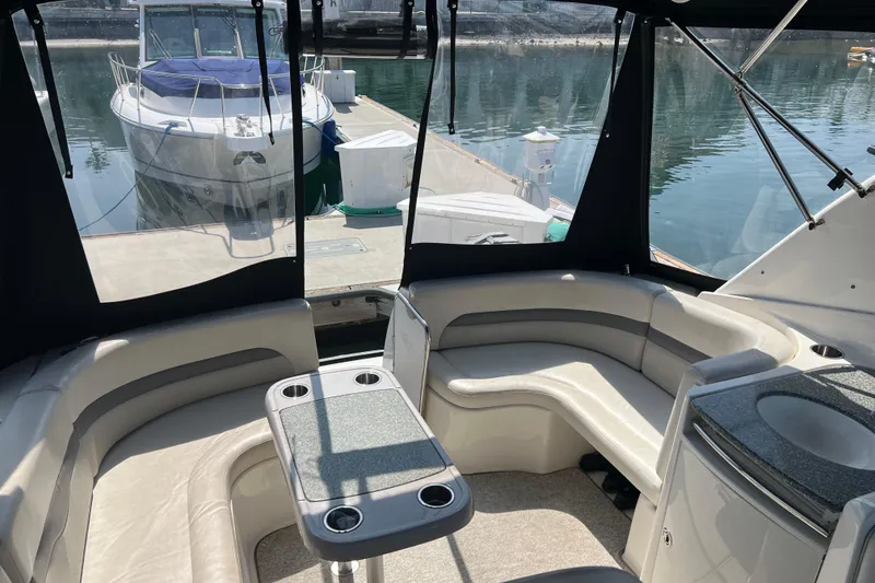 Slide: The Image of 2007 Chaparral Signature 330 boat interior with seating and table, docked at marina. - 11