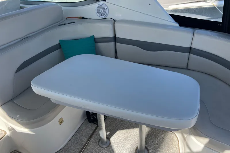 Slide: The Image of 2007 Chaparral Signature 330 interior with cushioned seating and table. - 13