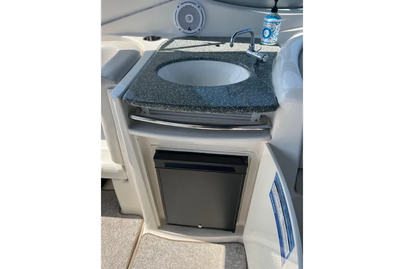 Slide: The Image of 2007 Chaparral Signature 330 boat kitchenette with sink and mini fridge. - 14