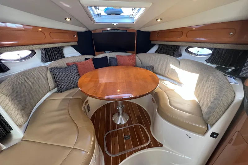Slide: The Image of Luxurious 2007 Chaparral Signature 330 cabin interior with elegant seating and wooden table. - 21