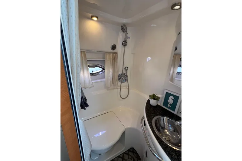 Slide: The Image of 2007 Chaparral Signature 330 bathroom with shower, sink, and porthole window. - 26