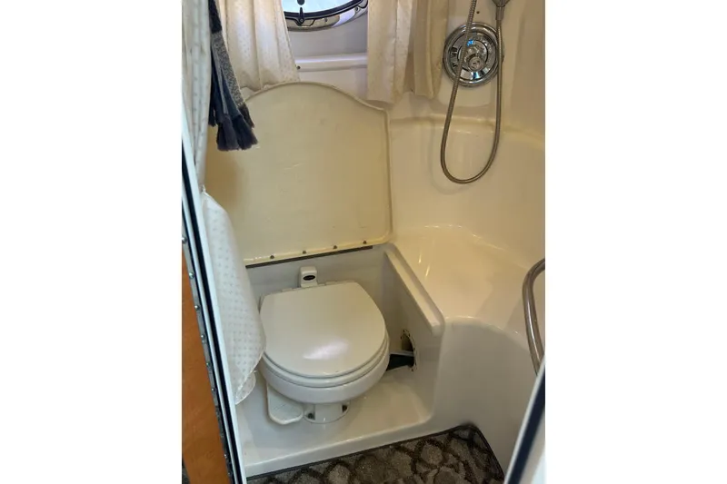 Slide: The Image of Compact bathroom in 2007 Chaparral Signature 330 boat with shower and toilet. - 27