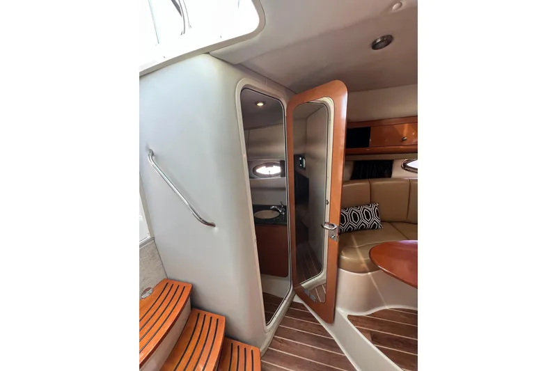 Slide: The Image of Interior of 2007 Chaparral Signature 330 yacht with wooden steps and cozy seating area. - 28