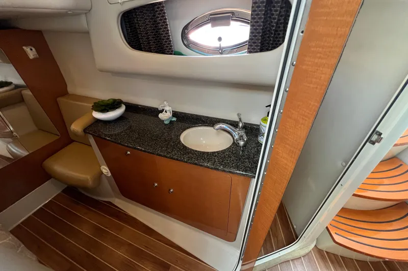 Slide: The Image of 2007 Chaparral Signature 330 bathroom with wooden accents and granite countertop. - 29