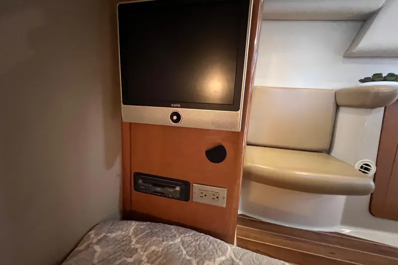 Slide: The Image of 2007 Chaparral Signature 330 cabin interior with TV, seating, and wood accents. - 31