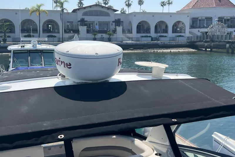 Slide: The Image of 2007 Chaparral Signature 330 yacht with radar, docked near waterfront buildings. - 9