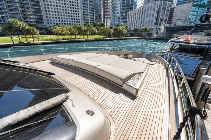 Slide: The Image of Luxurious 2020 Riva 100' Corsaro yacht deck with sun loungers, docked in urban marina. - 17