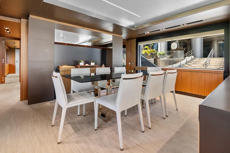 Slide: The Image of Luxurious dining area on 2020 Riva 100' Corsaro yacht with modern decor and large windows. - 32