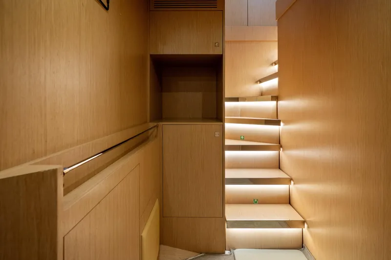 Slide: The Image of Modern wooden staircase with ambient lighting on a 2020 Riva 100' Corsaro yacht. - 40