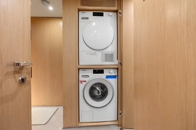 Slide: The Image of Laundry area with stacked washer and dryer on Riva 100' Corsaro yacht, 2020 model. - 46