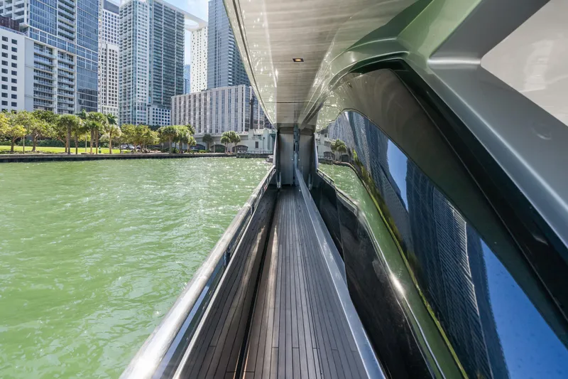 Slide: The Image of Side view of 2020 Riva 100' Corsaro yacht with city skyline reflection. - 75