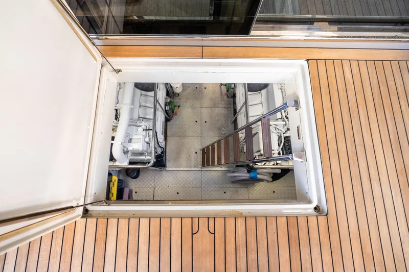 Slide: The Image of Engine room access hatch on 2020 Riva 100' Corsaro yacht with wooden deck. - 87