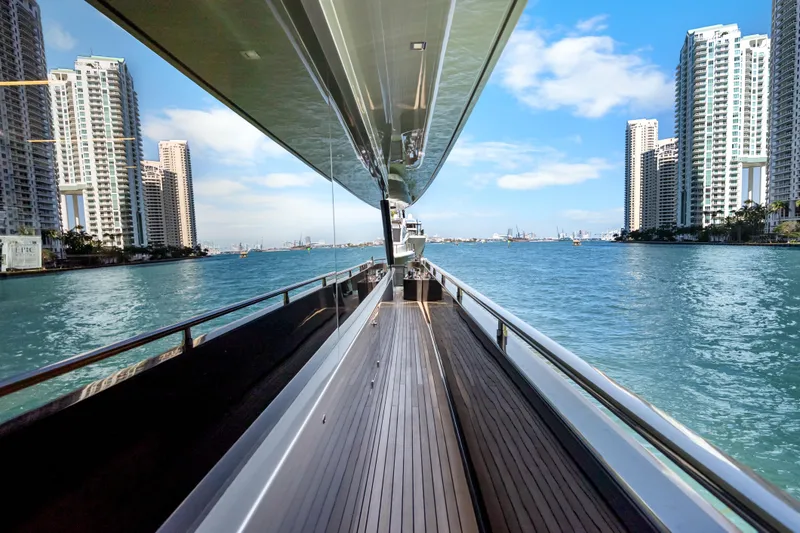 Slide: The Image of Luxurious 2020 Riva 100' Corsaro yacht cruising near city skyscrapers on a sunny day. - 88