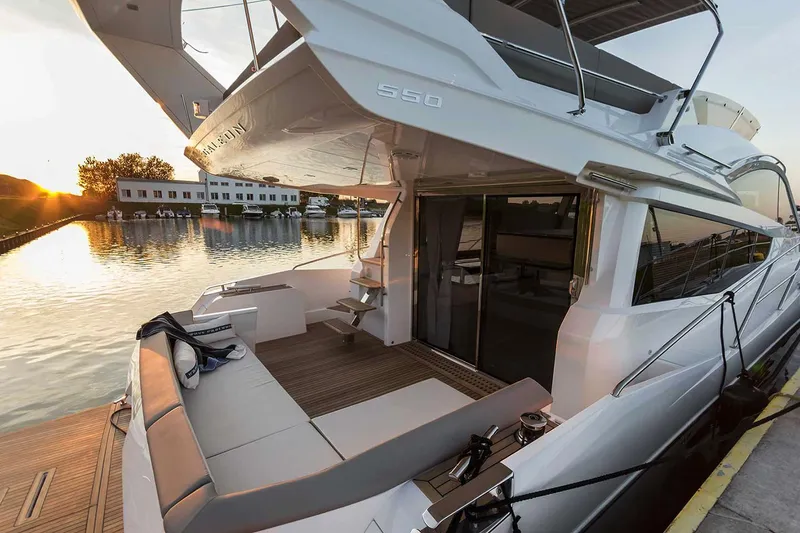 Slide: The Image of Manufacturer Provided Image: 2019 Galeon 550 Fly yacht docked at sunset, featuring spacious outdoor seating. - 4