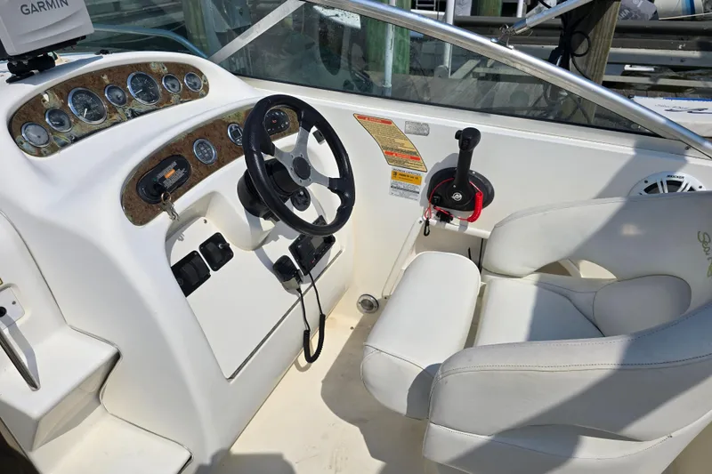 Slide: The Image of Cockpit of 2001 Sea Ray Sundancer 260 with steering wheel and control panel. - 19