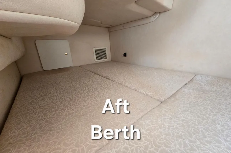 Slide: The Image of Aft berth of 2001 Sea Ray Sundancer 260, featuring comfortable bedding and compact design. - 29