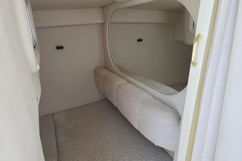 Slide: The Image of Interior cabin of 2001 Sea Ray Sundancer 260, featuring cozy sleeping area. - 30