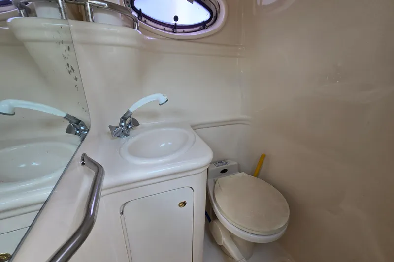 Slide: The Image of Bathroom interior of 2001 Sea Ray Sundancer 260 boat, featuring sink and toilet. - 32