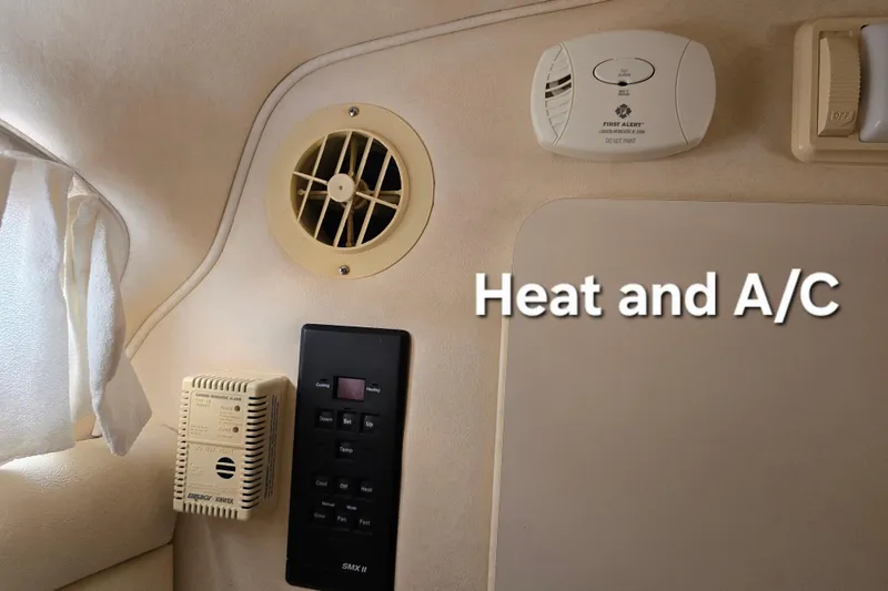 Slide: The Image of 2001 Sea Ray Sundancer 260 interior with heat and A/C controls. - 34