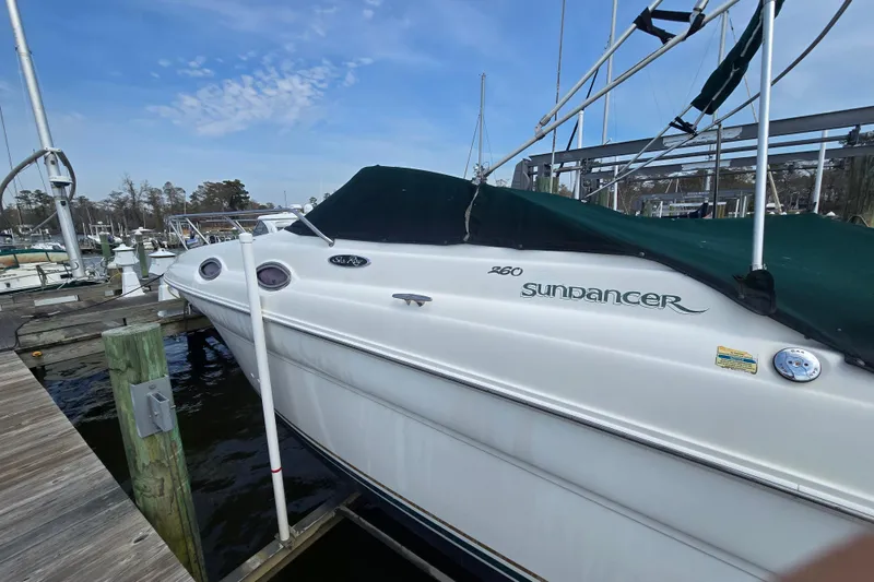 Slide: The Image of 2001 Sea Ray Sundancer 260 docked at marina under clear sky. - 4