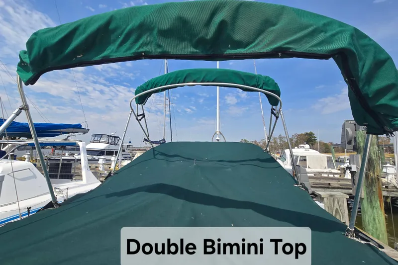 Slide: The Image of 2001 Sea Ray Sundancer 260 with double Bimini top at marina. - 5