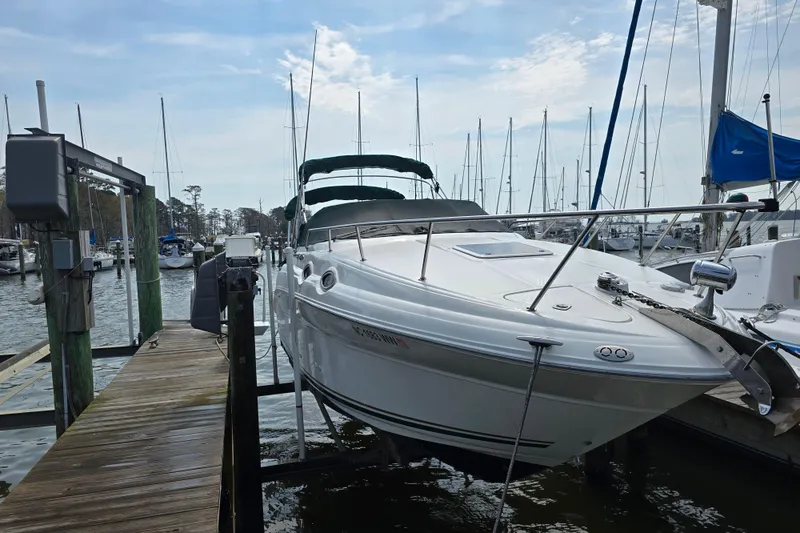 Slide: The Image of 2001 Sea Ray Sundancer 260 docked at marina with sailboats in background. - 7